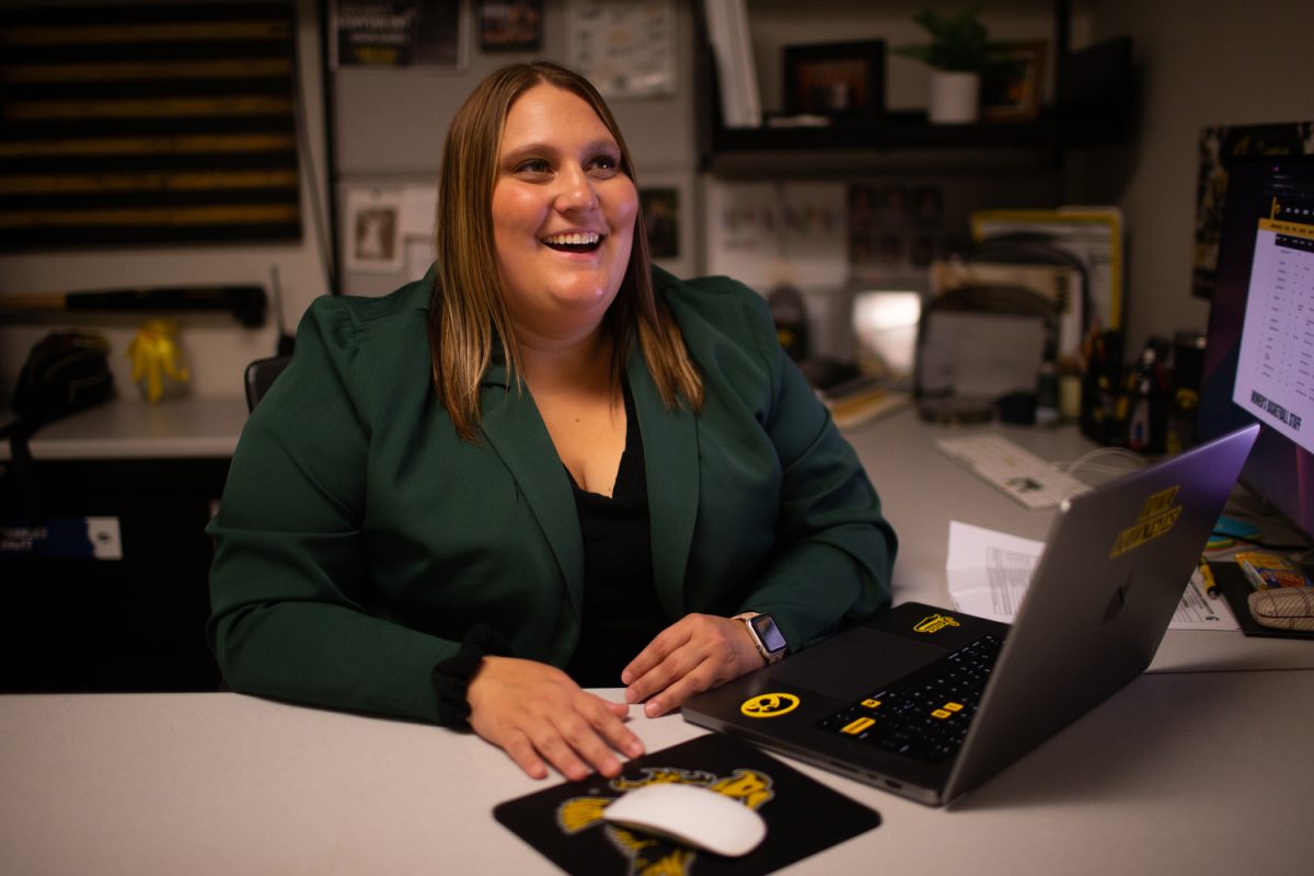Brandee Britt, director of UI athletics social media and digital strategy, smiles at Carver-Hawkeye Arena in Iowa City on Wednesday, Sept. 27, 2023. 
