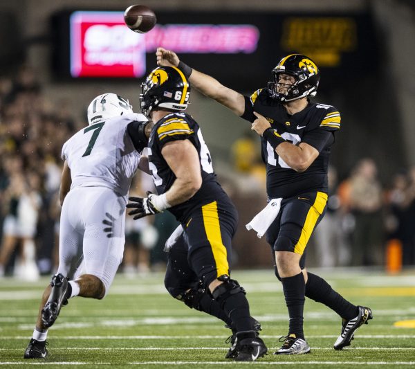 Iowa quarterback Deacon Hill throws a pass during a football game between Iowa and Michigan State at Kinnick Stadium in Iowa City on Saturday, Sept. 30, 2023. The Hawkeyes defeated the Spartans, 26-16. Hill averaged 4.3 yards per throw.