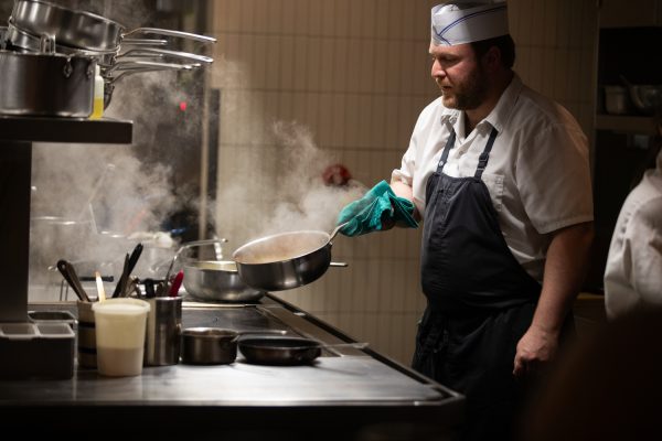 A chef cooks in the kitchen at the Webster in Iowa City on Saturday, Sept. 30, 2023.
