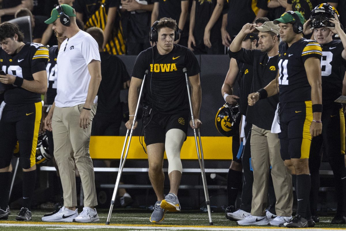 Iowa quarterback Cade McNamara stands on the sidelines with crutches after getting injured in the first quarter during a football game between Iowa and Michigan State at Kinnick Stadium on Saturday, Sept. 30, 2023. The Hawkeyes defeated the Spartans, 26-16.