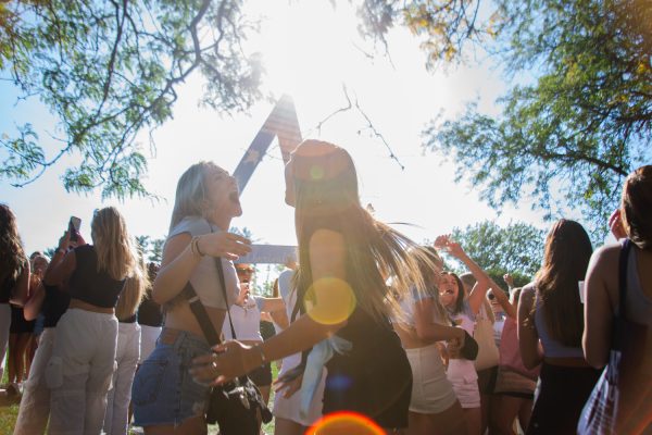 Two girls from Delta Delta Delta celebrate at the University of Iowa’s Bid Day in Hubbard Park in Iowa City on Sunday, Oct. 1, 2023. The potential new members accepted their bids.