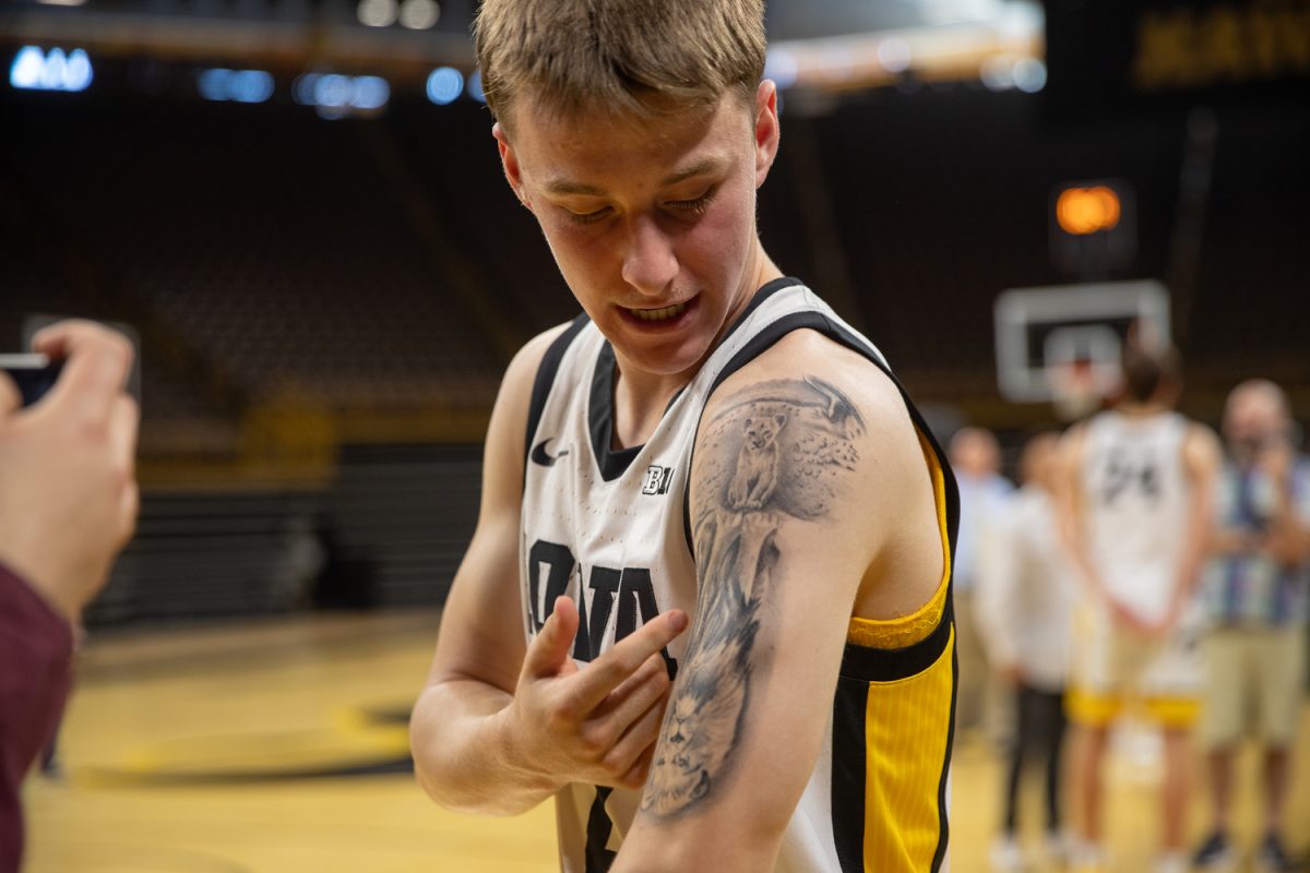 Iowa+guard+Brock+Harding+tells+the+story+of+his+tattoo+to+media+during+the+2023+Men%E2%80%99s+Basketball+media+day+at+Carver-Hawkeye+Arena+on+Monday+Oct.+2%2C+2023.+Harding+is+a+freshman+point+guard+from+Moline%2C+Illinois.