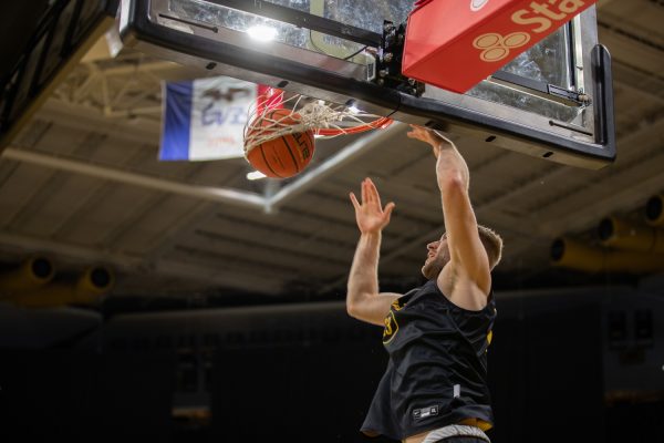 Iowa forward Ben Krikke dunks a basketball during the 2023 Men’s Basketball media day at Carver-Hawkeye Arena on Monday Oct. 2, 2023.  Krikke is a recent transfer from Valparaiso University where he averaged 19.4 points per game.