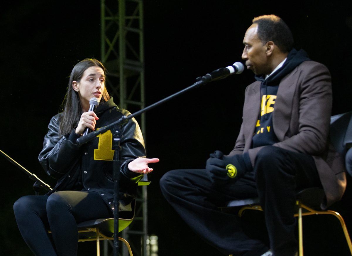 Iowa guard Caitlin Clark talks in front of a crowd with ESPN analyst Stephen A. Smith and media executive Mark Shapiro on the Pentacrest in Iowa City on Friday, Oct. 6, 2023. Smith, Shapiro and Clark participated in a publicized conversation titled “Beyond the Game” as part of the 2023 University of Iowa Homecoming. “The hardest thing is (to decide) whether I stay another year or whether this is my last year. But right now, we have an amazing year coming up here. Let’s focus on that,” Clark said. 