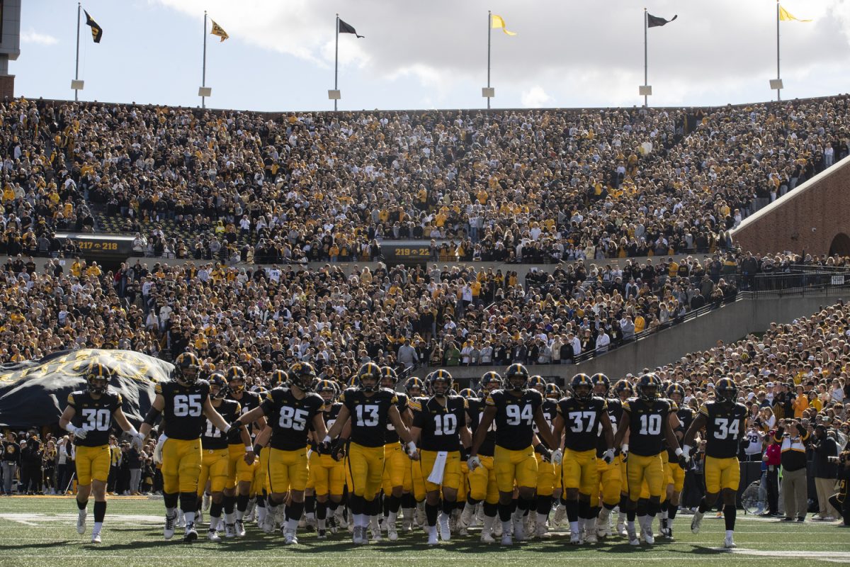 Iowa football players run onto the field before the the Iowa homecoming football game between Iowa and Purdue at Kinnick Stadium in Iowa City on Saturday, Oct. 7, 2023. The Hawkeyes defeated the Boilermakers 20-14.
