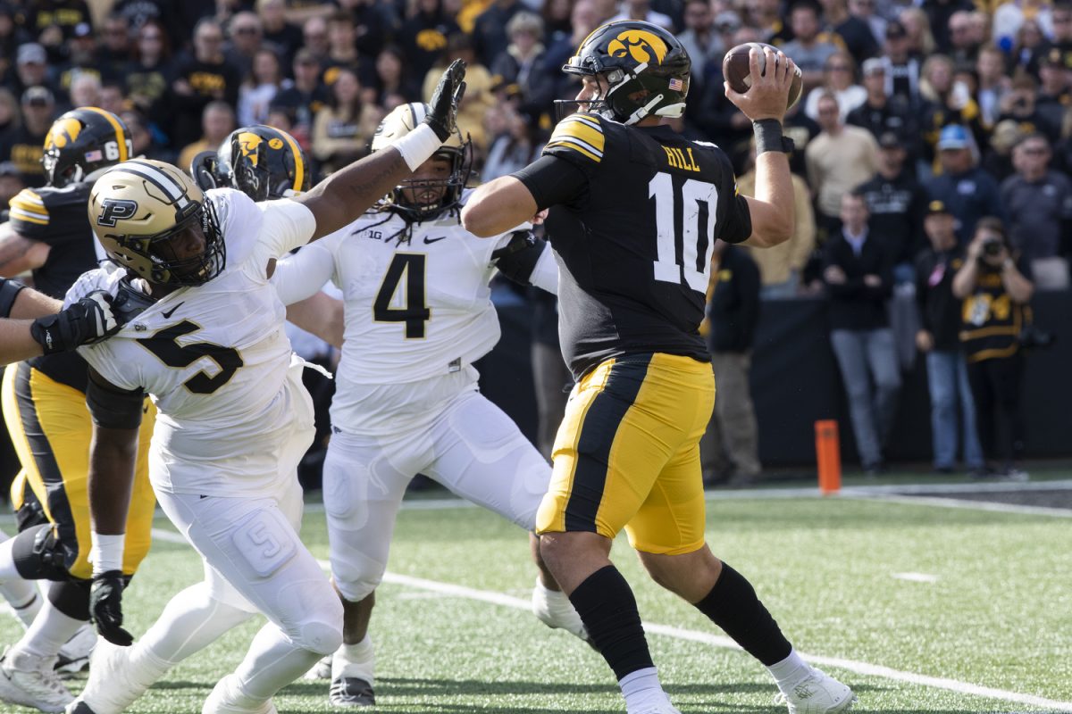 Iowa quarterback Deacon Hill prepares to throw the ball during the the Iowa homecoming football game between Iowa and Purdue at Kinnick Stadium in Iowa City on Saturday, Oct. 7, 2023. The Hawkeyes defeated the Boilermakers 20-14. Hill totaled 110 yards and one touchdown against Purdue.