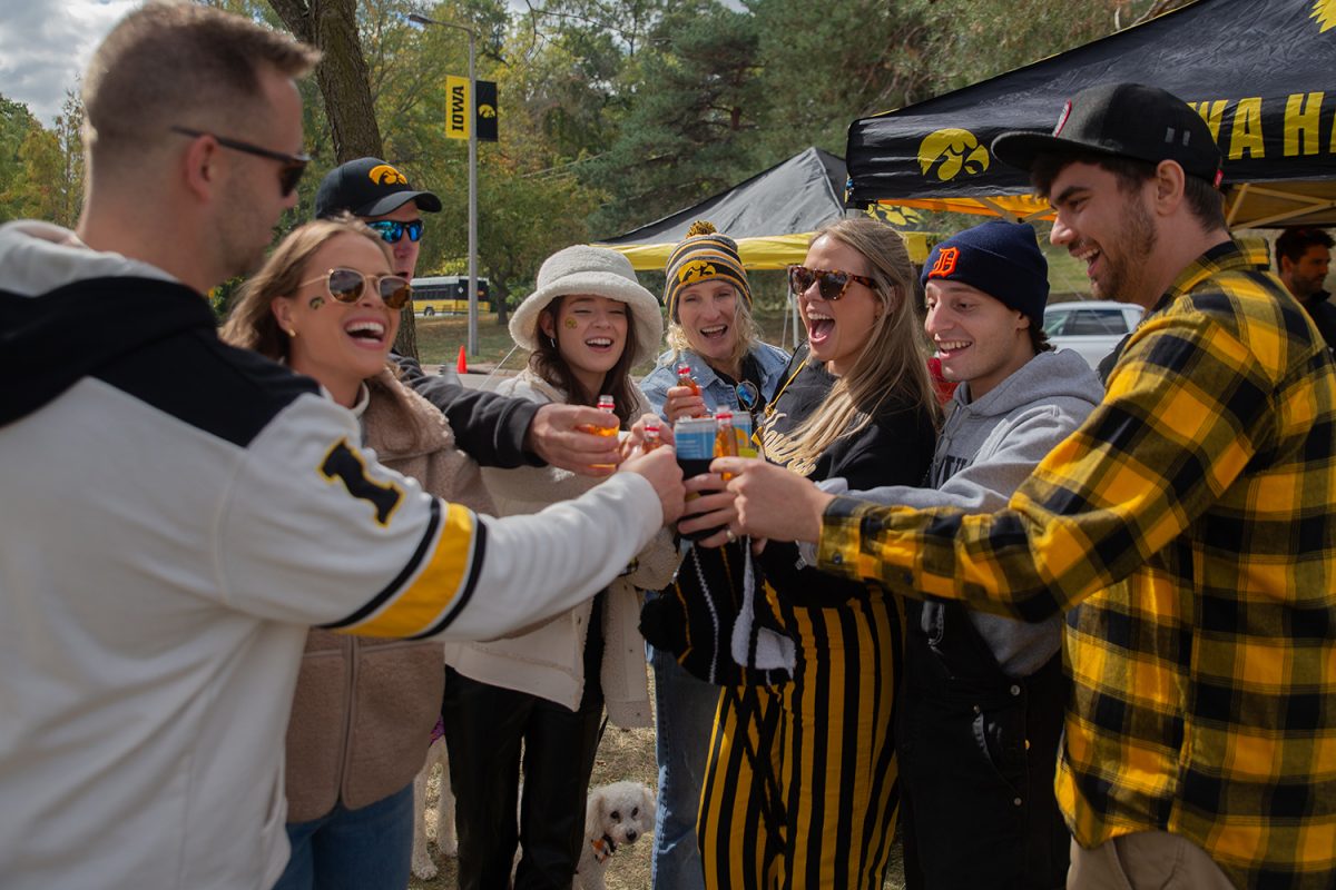 The Meister family celebrates before a football game between Iowa and Purdue in Iowa City on Saturday, Oct. 7, 2023. 
