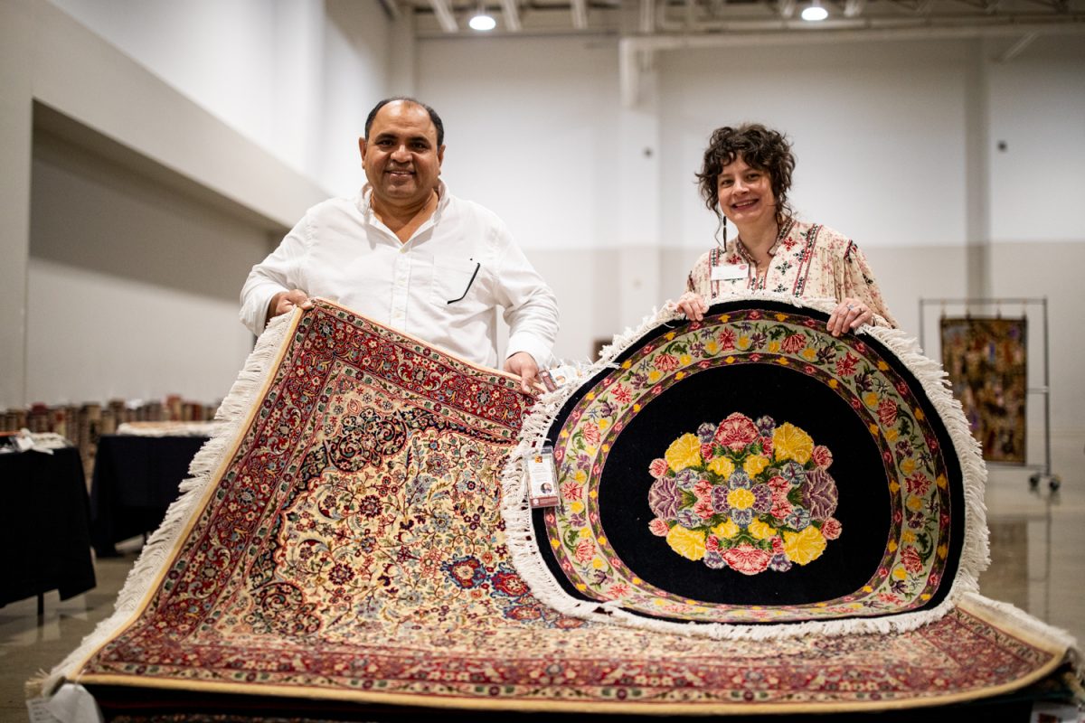 Rug craftsman Yousaf Chaman and executive director of Ten Thousand Villages Iowa City Liz Preciado Genell pose for a portrait at the Hyatt Regency Coralville Hotel and Conference Center in Coralville, Iowa, on Thursday, Oct. 12, 2023. The event was led by Iowa City’s Ten Thousand Villages and Yousaf Chaman to raise money for Pakistan after recent flood damage. 