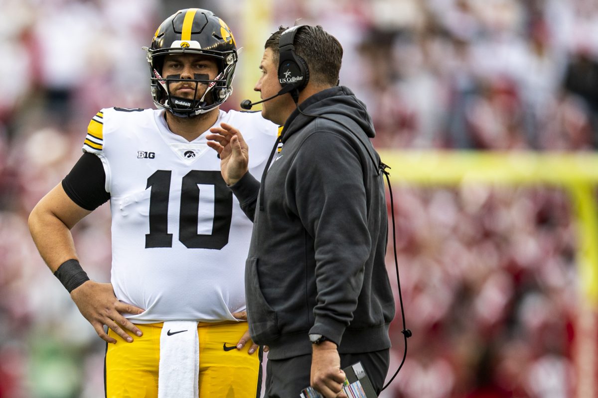 Iowa offensive coordinator Brian Ferentz speaks with quarterback Deacon Hill during a football game between Iowa and Wisconsin at Camp Randall Stadium on Saturday, Oct. 14, 2023. Hill passed for 37 yards. The Hawkeyes defeated the Badgers, 15-6.