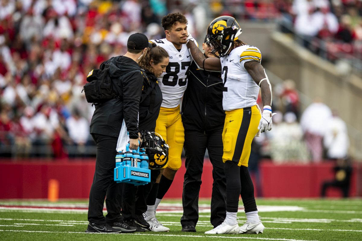 Iowa tight end Erick All recieves support after an injury during a football game between Iowa and Wisconsin at Camp Randall Stadium on Saturday, Oct. 14, 2023. All was injured in the first quarter and was out for the remainder of the game. The Hawkeyes defeated the Badgers, 15-6.