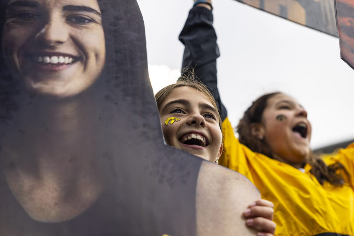 Leah Robinson holds a Caitlin Clark cutout before Crossover at Kinnick, a women’s exhibition basketball game between Iowa and DePaul, at Kinnick Stadium in Iowa City on Sunday, Oct. 15, 2023. The Hawkeyes enter the 2023-24 season after advancing to the NCAA Championship for the first time in program history last year and winning a program-best 31 games in a single season in the 2022-23 season. (Grace Smith/The Daily Iowan)