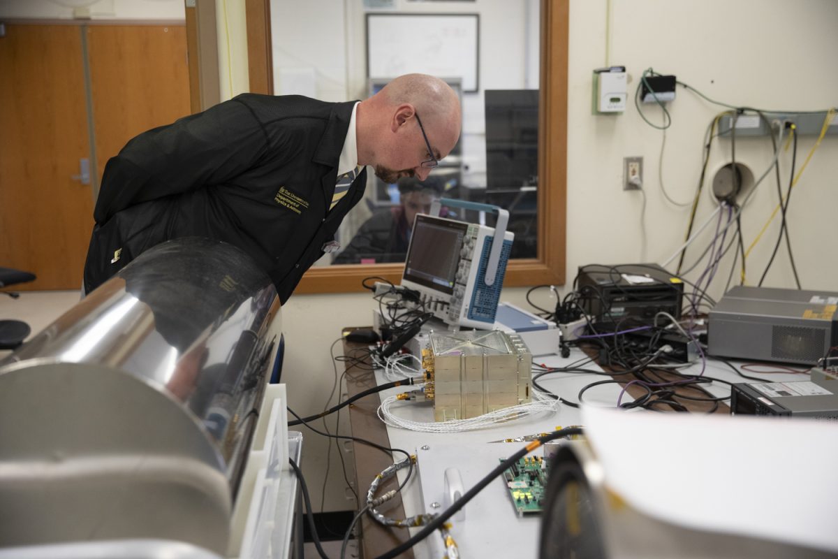 Dr. David Miles inspects an instrument while engineers run capability tests at Van Allen Hall in Iowa City on Monday, Oct. 16, 2023. Dr. Miles directs operations for Tandem Reconnection and Cusp Electrodynamics Reconnaissance Satellites, a project which is dedicated to studying how solar material interacts with Earths Magnetic Field.