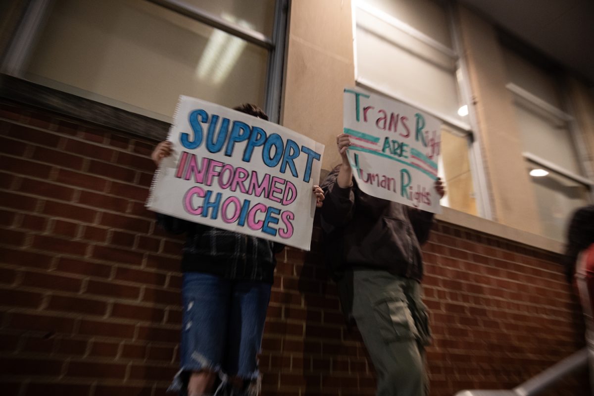 Two activists protest outside the Iowa Memorial Union during a Young Americans for Freedom hosted event in the IMU’s Blackbox Theater in Iowa City featuring Chloe Cole, a person who detransitioned, on Monday, Oct. 16, 2023. Pro-Transgender activists protested outside the IMU and later blocked the N Madison St. and W Jefferson St. intersection. The protest concluded with protests in front of University of Iowa president Barbara Wilson’s residence on Church St. 
