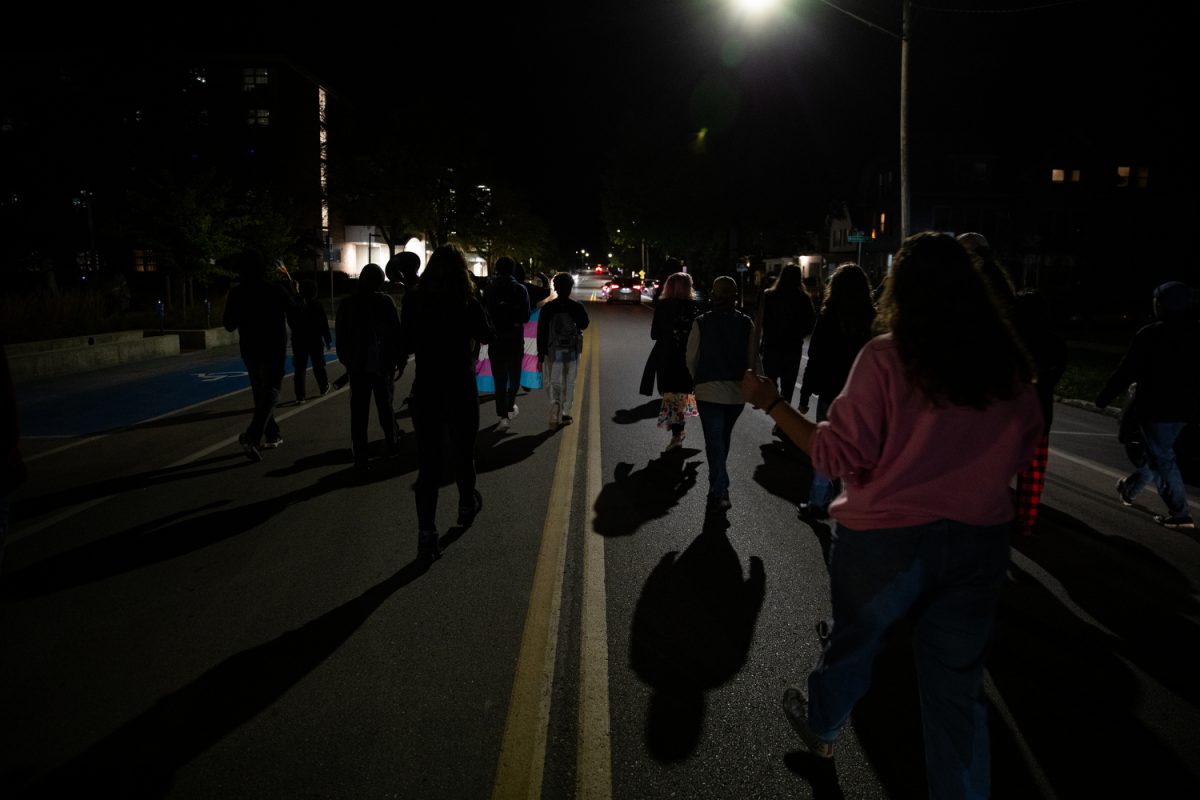 Activists walk toward Barbara Wilson’s residence after a Young Americans for Freedom event in the Iowa Memorial Union’s Blackbox Theater in Iowa City featuring speaker Chloe Cole, a person who detransitioned, on Monday, Oct. 16, 2023. 