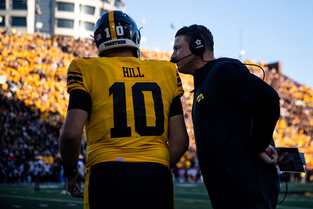 Iowa offensive coordinator Brian Ferentz speaks to quarterback Deacon Hill during a football game between No. 24 Iowa and Minnesota at Kinnick Stadium in Iowa City on Saturday, Oct. 21, 2023. The Golden Gophers defeated the Hawkeyes, 12-10.