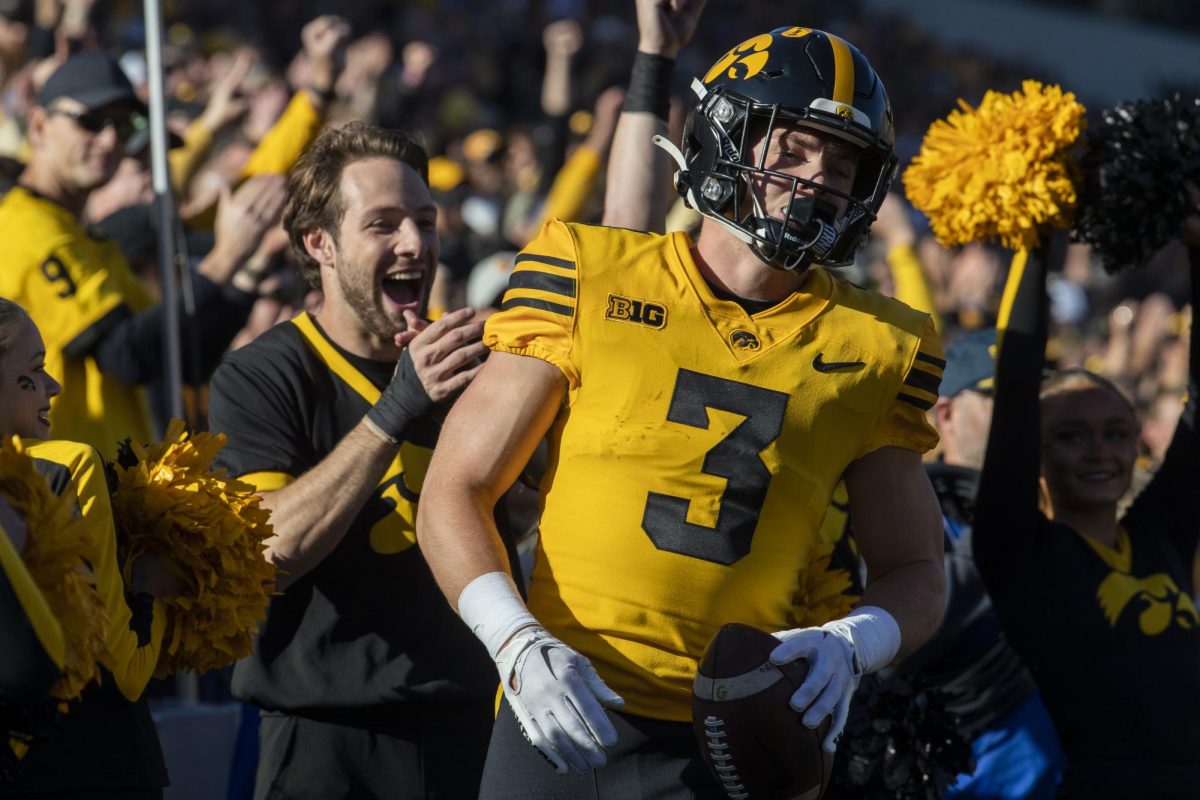Fans and spirit squad members cheer for Iowa defensive back Cooper DeJean after a catch during a football game between Iowa and Minnesota at Kinnick Stadium in Iowa City on Saturday, Oct. 21, 2023. The Gophers defeated the Hawkeyes 12-10. 