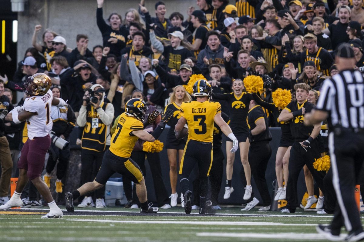 Fans cheer Iowa defensive back Cooper DeJean makes a touchdown during a football game between Iowa and Minnesota at Kinnick Stadium in Iowa City on Saturday, Oct. 21, 2023. In an upset to fans, Referees called that DeJean waived fair catch on his touchdown, bring the score form 16-10 Iowa to the games final score of 12-10, with the Gophers defeating the Hawkeyes.