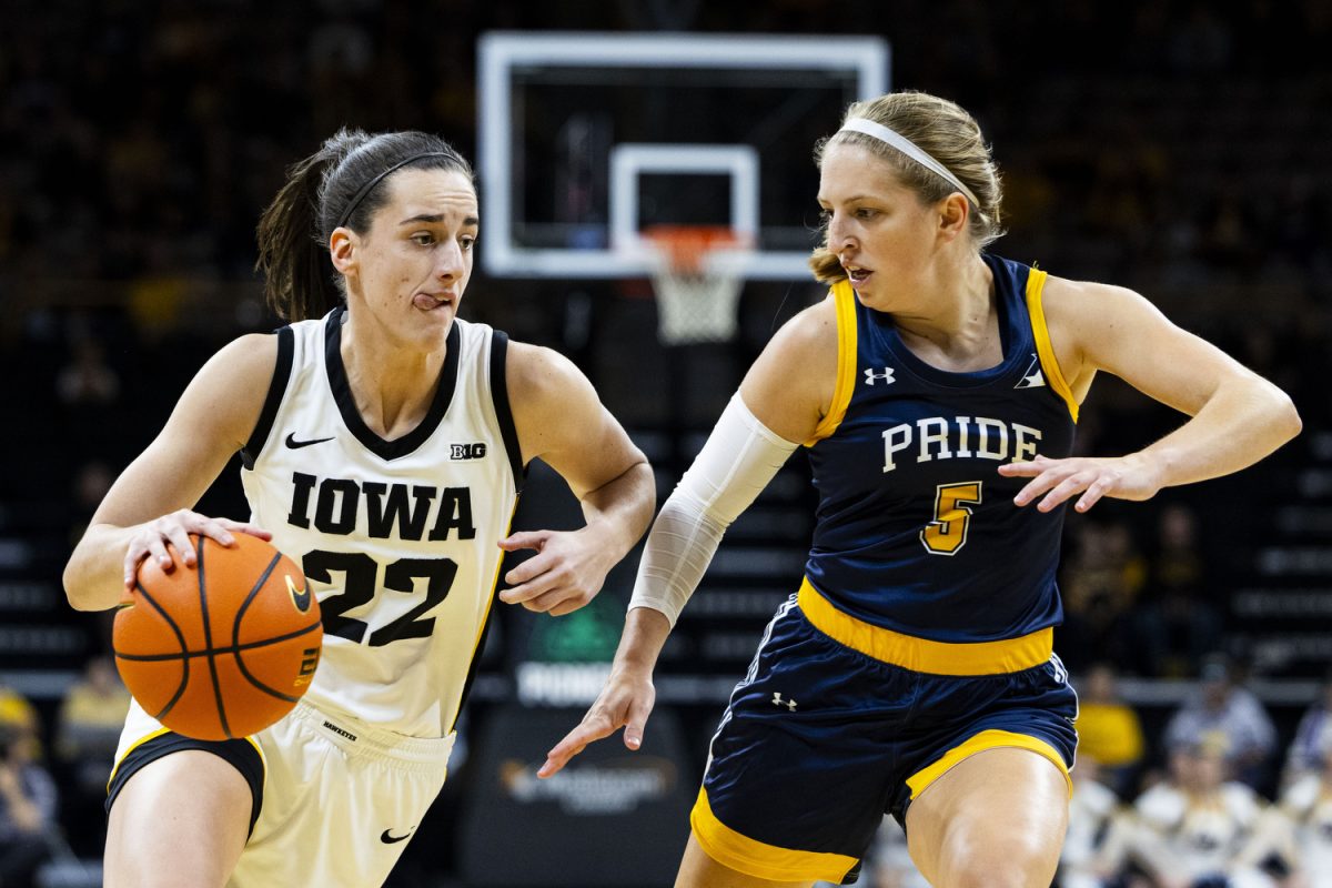 Iowa guard Caitlin Clark dribbles the ball as Clarke guard Nicole McDermott defends her toward the basket during an exhibition women’s basketball game between Iowa and Clarke University at Carver-Hawkeye Arena on Sunday, Oct. 22, 2023. The matchup marks Iowa’s first game in Carver-Hawkeye Arena for the 2023-24 season. Clark played for 15 minutes and 43 seconds, scoring 24 points for Iowa. McDermott, a Cascade, Iowa, native, scored 10 points for Clarke. The Hawkeyes defeated the Pride, 122-49.