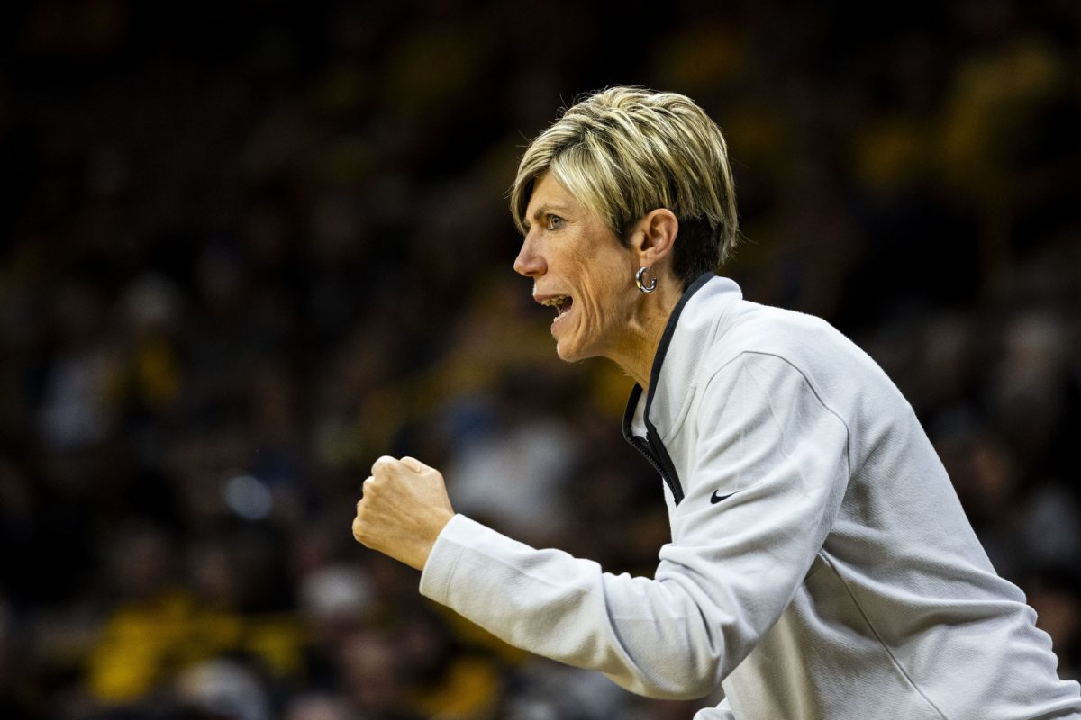 Iowa associate head coach Jan Jensen cheers during an exhibition women’s basketball game between Iowa and Clarke University at Carver-Hawkeye Arena on Sunday, Oct. 22, 2023. The matchup marks Iowa’s first game in Carver-Hawkeye Arena for the 23-24 season. Iowa shot 51-of-81 in the paint. The Hawkeyes defeated the Pride, 122-49.