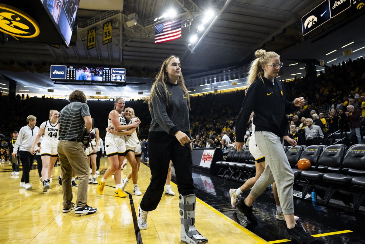 Iowa forward AJ Ediger and Iowa forward Ava Jones walk off the court during an exhibition women’s basketball game between Iowa and Clarke University at Carver-Hawkeye Arena on Sunday, Oct. 22, 2023. The matchup marks Iowa’s first game in Carver-Hawkeye Arena for the 23-24 season. Ediger was out for the game after sustaining a foot injury. Iowa head coach Lisa Bluder said it is a non-contact injury to her foot and Ediger will be back. The Hawkeyes defeated the Pride, 122-49.