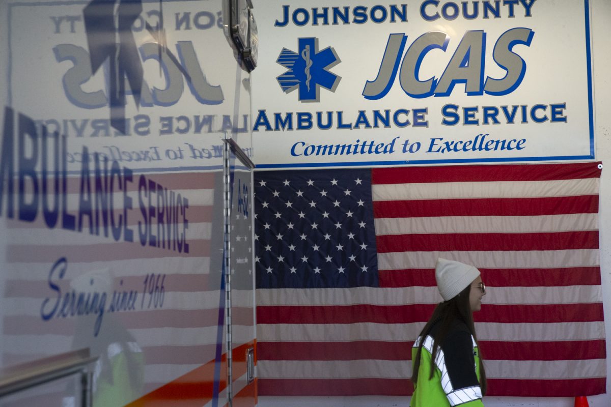 A Johnson County Ambulance Service worker walks towards a morning group huddle at the Johnson County Ambulance Medical Examiner Building on Saturday, Oct. 21, 2023. 