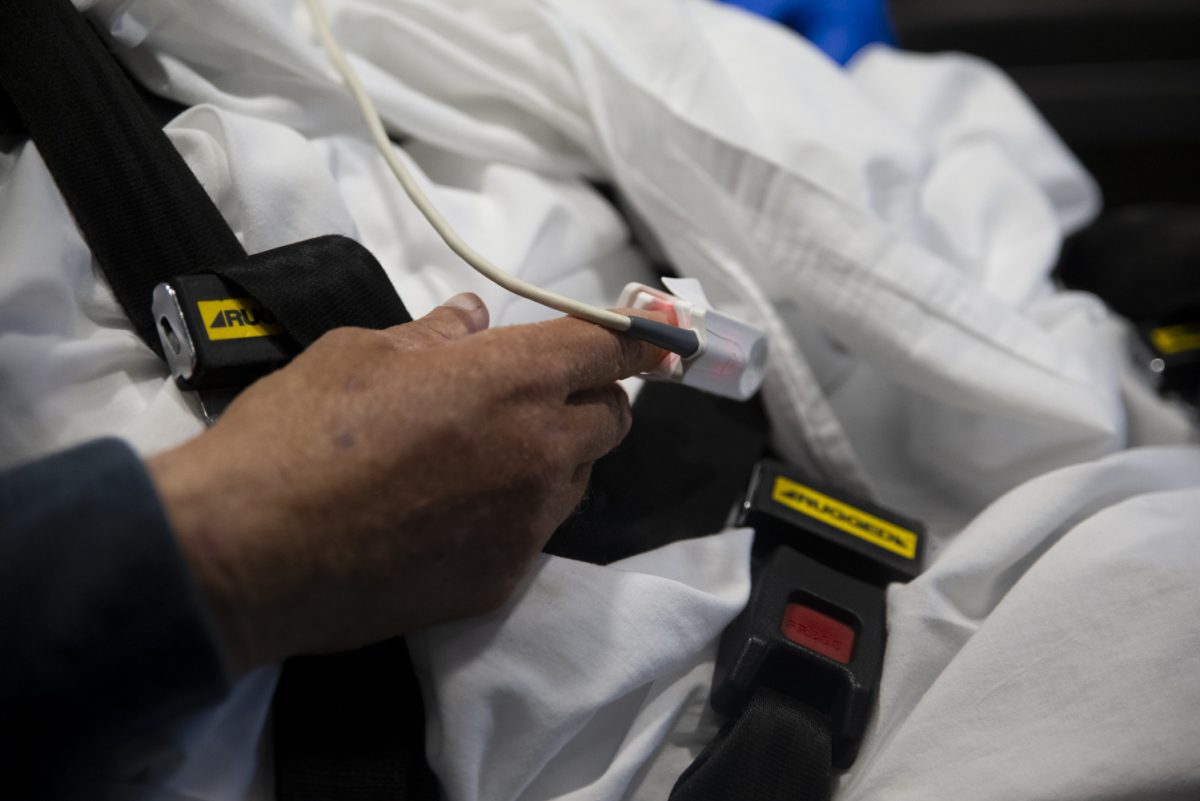 A pulse oximeter is applied on a patient’s finger at the back of an ambulance in Iowa City on Saturday, Oct. 21, 2023. 