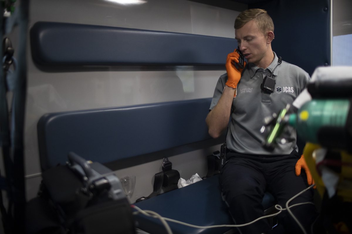 Johnson County Ambulance Service Paramedic Field Supervisor Andreas Wilz calls while attending a patient inside an ambulance in Iowa City on Friday, Oct. 20, 2023. 