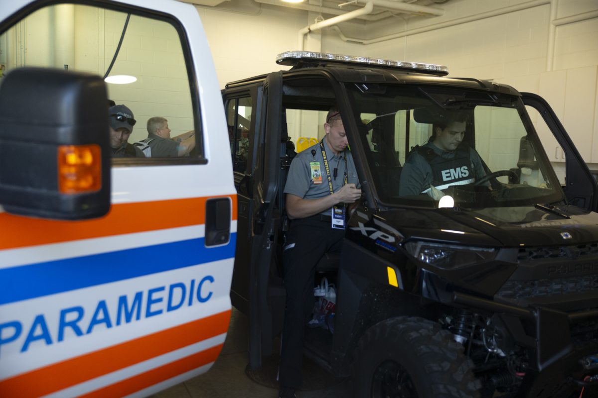 Paramedic Field Supervisor Andreas Wilz and EMT Michael Janes prepare for the football game between Iowa and Minnesota at the Johnson County Ambulance Medical Examiner Building on Saturday, Oct. 21, 2023. The ambulance service received a Firehouse Subs grant of $33,444 for a utility terrain vehicle. The vehicle is used for high foot traffic occasions during events. 