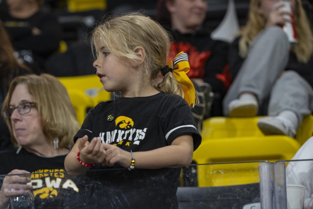 A Hawkeye fan watches a volleyball match between Maryland and Iowa in the Xtream Arena in Coralville on Oct. 28, 2023. The Terrapins defeated the Hawkeyes 3-0. 