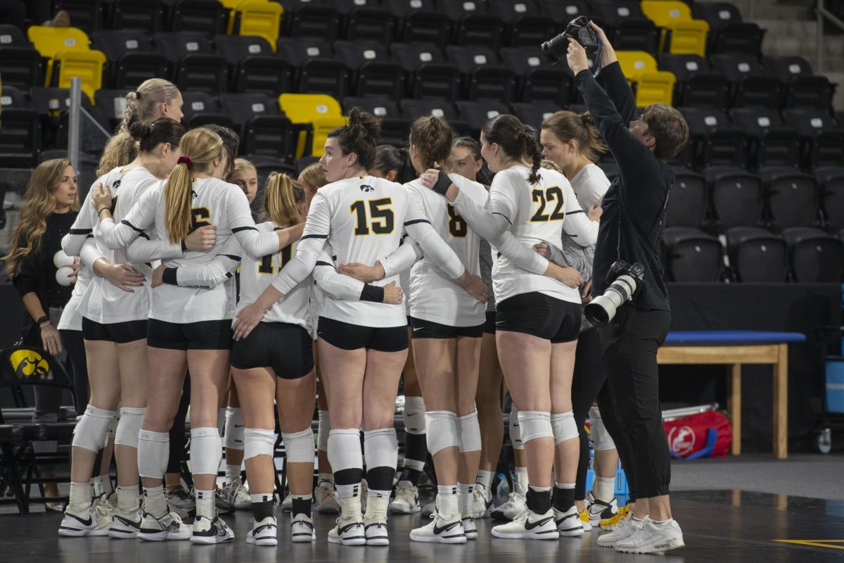 The University of Iowa’s media team takes photos of players in a huddle during a volleyball match between Maryland and Iowa at Xtream Arena in Coralville on Oct. 28, 2023. The Terrapins defeated the Hawkeyes 3-0. 