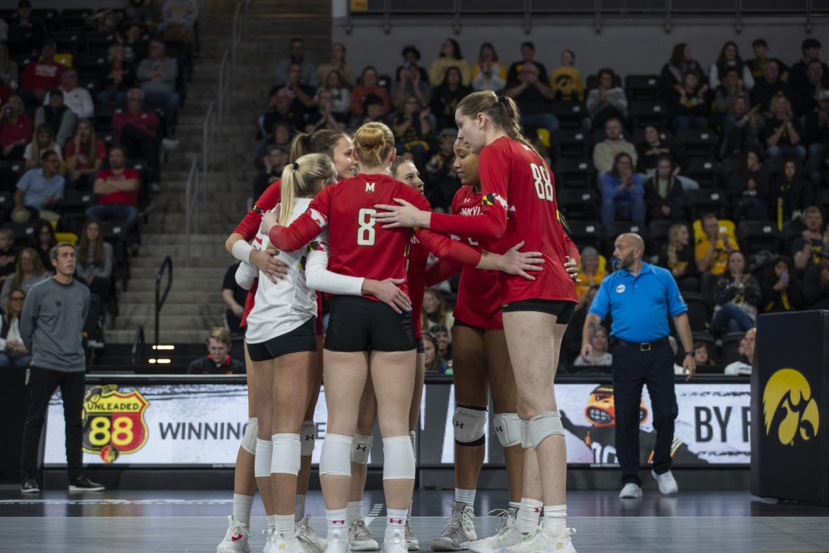 Maryland players talk strategy during a volleyball match between Maryland and Iowa in the Xtream Arena in Coralville on Oct. 28, 2023. The Terrapins defeated the Hawkeyes 3-0. 