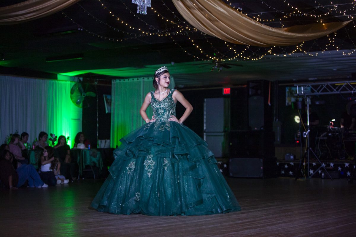 Angelly Gonzales smiles on stage at her Quinceañera at Flamas Nightclub in West Liberty, Iowa on Sept. 23rd, 2023.
