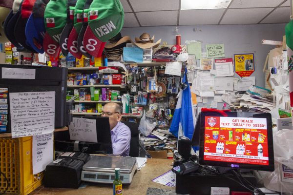 Antonio Sosa works the cashier desk at his convenience store in West Liberty, Iowa on Saturday, Sept. 23, 2023.