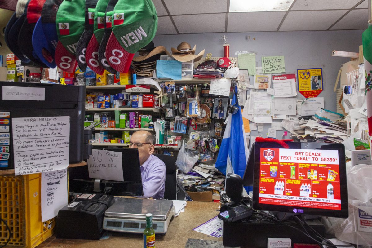 Antonio Sosa works the cashier desk at his convenience store in West Liberty, Iowa on Sept. 23, 2023.
