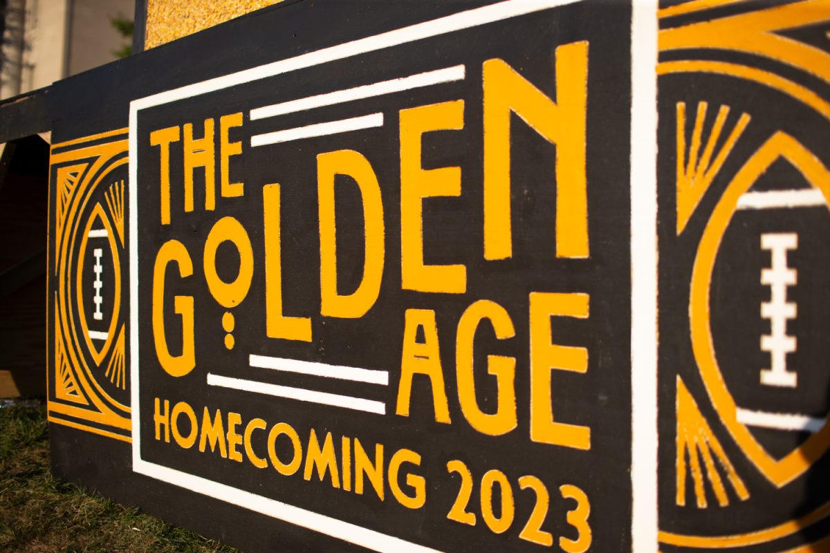 A sign on the corn monument for the 2023 UI Homecoming is seen during the installation on Sunday, Oct. 1, 2023. The UI Artineers and American Society of Civil Engineers (ASCE) student chapter designs, builds and assembles the corn monument every year as a homecoming tradition. (Shuntaro Kawasaki/The Daily Iowan)