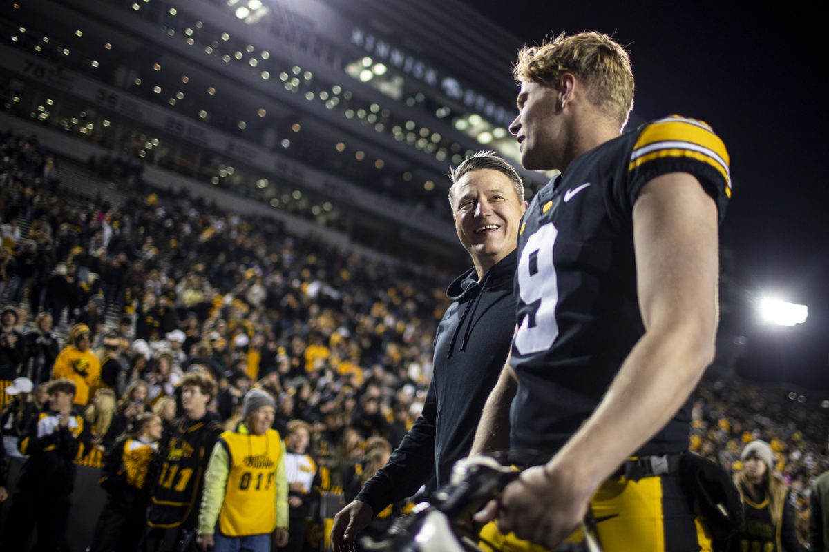 Iowa offensive coordinator Brian Ferentz and Iowa punter Tory Taylor exit the field after a football game between Iowa and Rutgers at Kinnick Stadium on Saturday, Nov. 11, 2023. The Hawkeyes defeated the Scarlet Knights, 22-10.