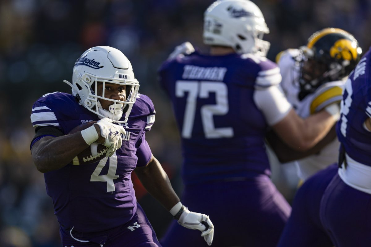 Northwestern running back Cam Porter carries the ball during the 2023 Wildcats Classic, a football game between Iowa and Northwestern at Wrigley Field in Chicago, on Saturday, Nov. 4, 2023. Porter rushed for 36 yards. The Hawkeyes defeated the Wildcats, 10-7.