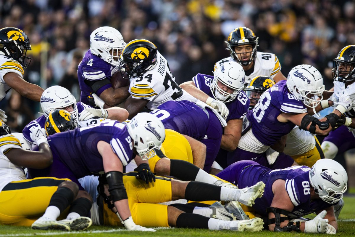 Iowa+linebacker+Jay+Higgins+stops+Northwestern+running+back+Cam+Porter+from+scoring+a+touchdown+during+the+2023+Wildcats+Classic%2C+a+football+game+between+Iowa+and+Northwestern+at+Wrigley+Field+in+Chicago+on+Saturday%2C+Nov.+4%2C+2023.+Higgins+had+12+total+tackles.+The+Hawkeyes+defeated+the+Wildcats%2C+10-7.