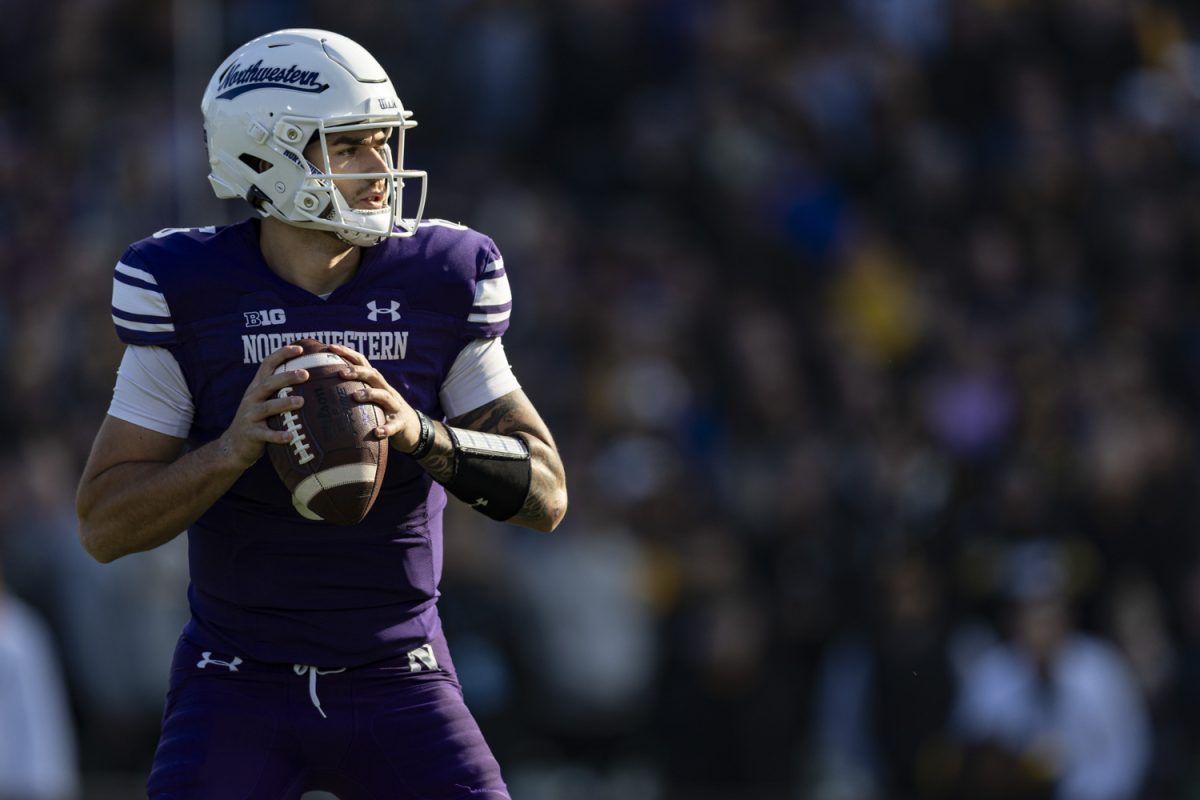 Northwestern+quarterback+Brendan+Sullivan+prepares+to+throw+the+ball+during+the+2023+Wildcats+Classic%2C+a+football+game+between+Iowa+and+Northwestern+at+Wrigley+Field+in+Chicago%2C+on+Saturday%2C+Nov.+4%2C+2023.+Sullivan+caught+12+completions+on+19+attempts.+The+Hawkeyes+defeated+the+Wildcats%2C+10-7.