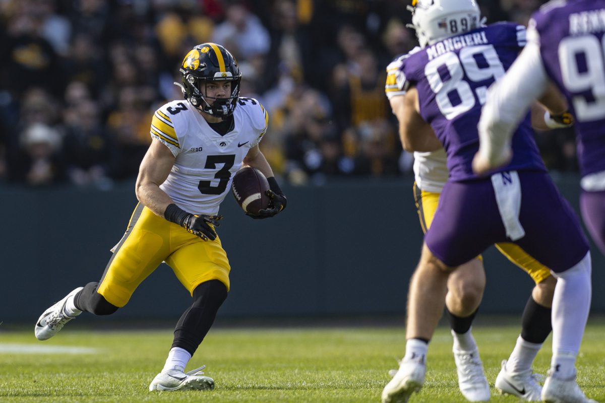Iowa defensive back Cooper DeJean returns the ball during the 2023 Wildcats Classic, a football game between Iowa and Northwestern at Wrigley Field in Chicago, on Saturday, Nov. 4, 2023. The Hawkeyes defeated the Wildcats, 10-7. 