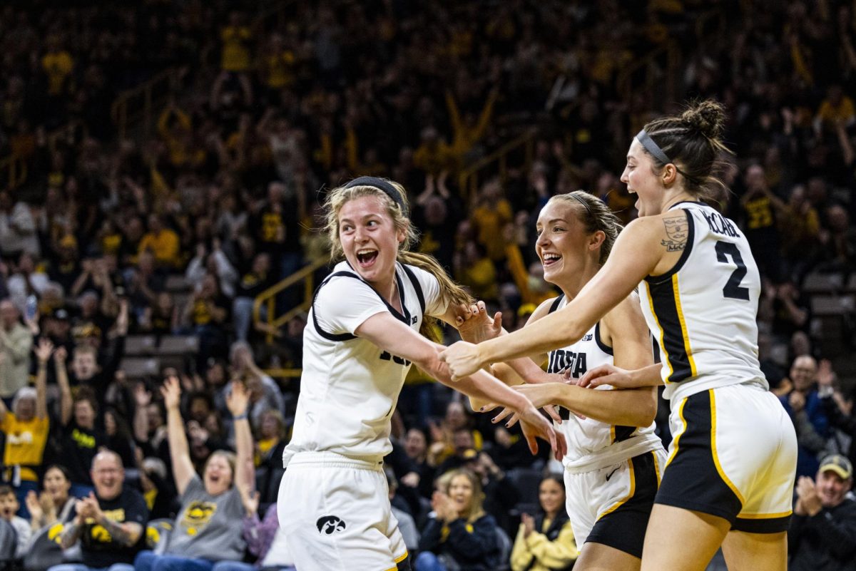 Iowa guard Molly Davis, guard Kylie Feuerbach, and guard Taylor McCabe celebrate a play during a home opener basketball game between No. 3 Iowa and Fairleigh Dickinson at Carver-Hawkeye Arena on Monday, Nov. 6, 2023. 