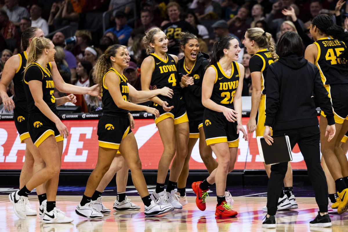 Iowa celebrates during a timeout during the Ally Tipoff, a basketball game between No. 3 Iowa and No. 8 Virginia Tech at Spectrum Center in Charlotte, N.C., on Thursday, Nov. 9, 2023. Iowa scored 42 points in the paint compared to Virginia Tech’s 20.  The Hawkeyes defeated the Hokies, 80-76. 