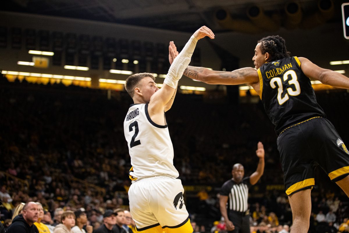 Iowa+Guard+Brock+Harding+shoots+a+three+with+a+defender+in+his+face+during+a+men%E2%80%99s+basketball+game+between+Iowa+and+Alabama+State+at+Carver-Hawkeye+Arena+on+Friday%2C+Nov.+10%2C+2023.+The+Hawkeyes+defeated+the+Hornets+98-67.+Harding+had+seven+assists+against+the+Hornets