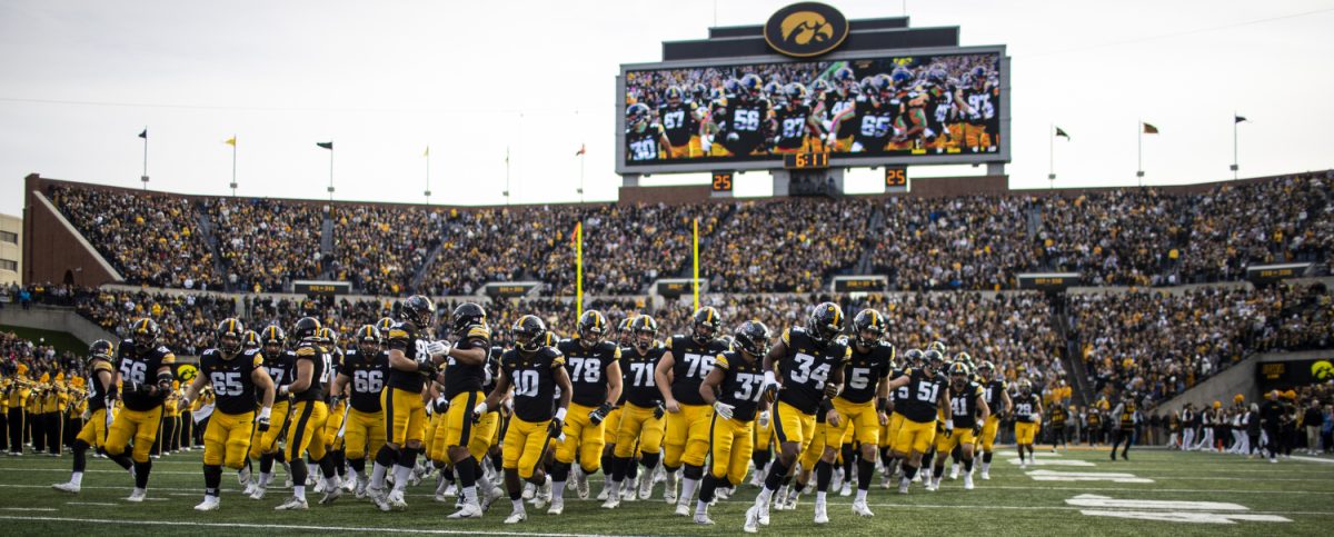 Iowa players run onto the field before a football game between Iowa and Rutgers at Kinnick Stadium on Saturday, Nov. 11, 2023. Iowa had 402 total yards compared to Rutgers’ 127. The Hawkeyes defeated the Scarlet Knights, 22-0.