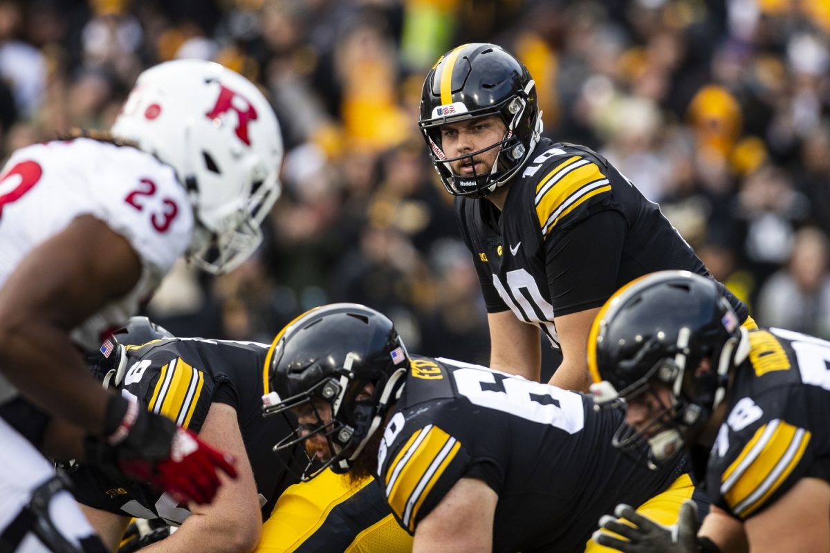 Iowa quarterback Deacon Hill prepares to catch a snap during a football game between Iowa and Rutgers at Kinnick Stadium on Saturday, Nov. 11, 2023. Hill threw for 223 yards and a touchdown. The Hawkeyes defeated the Scarlet Knights, 22-0.