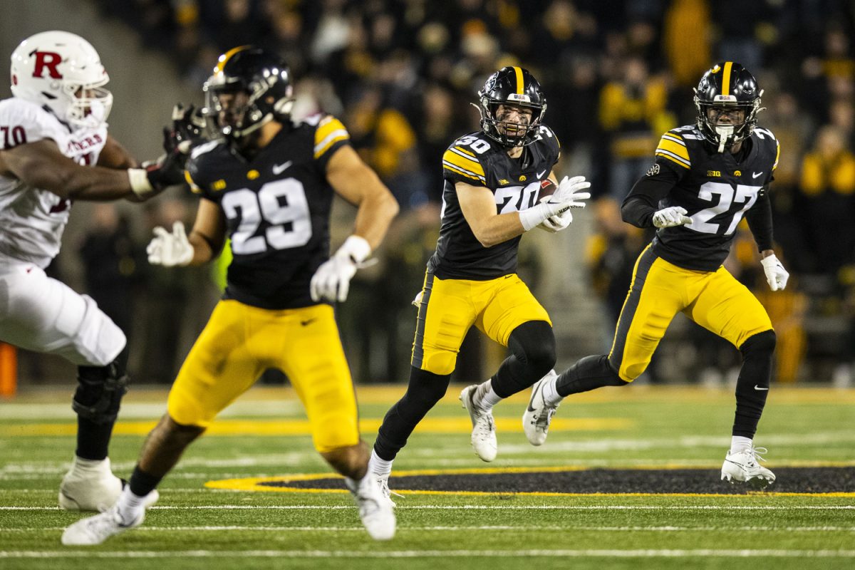 Iowa defensive back Quinn Schulte runs the ball after catching an interception during a football game between Iowa and Rutgers at Kinnick Stadium on Saturday, Nov. 11, 2023. Schulte intercepted the pass in the 4th quarter, running 39 yards. The Hawkeyes defeated the Scarlet Knights, 22-0.