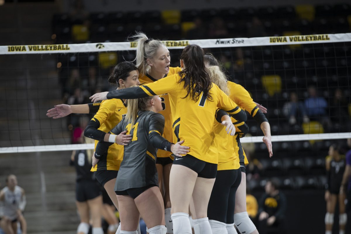 The Iowa Hawkeyes celebrate after winning a point during a volleyball match between Iowa and Northwestern at Xtream Arena in Coralville on Sunday, Nov. 12, 2023. The Wildcats defeated the Hawkeyes, 3-0.