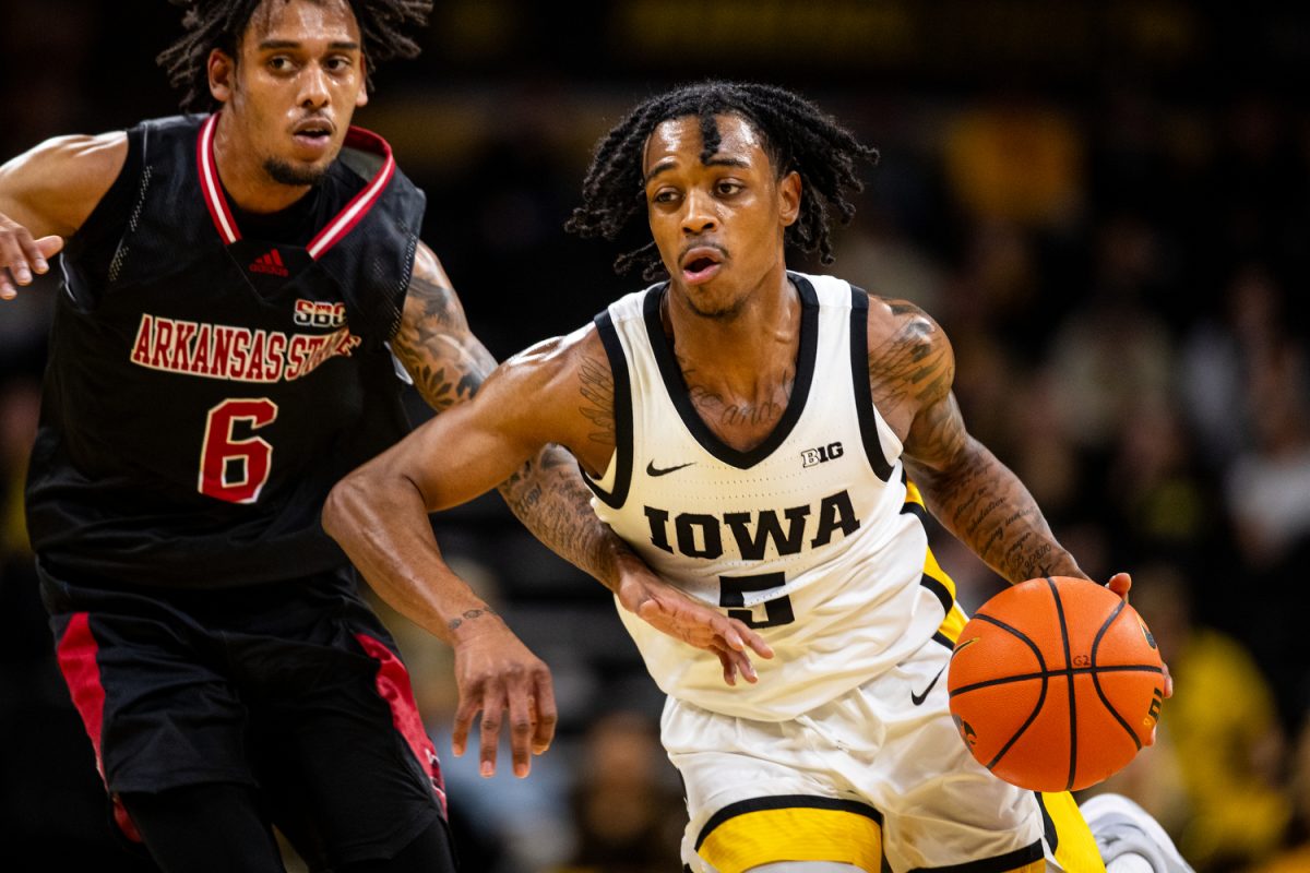 Iowa guard Desonte Bowen dribbles past a defender during a men’s basketball game between Iowa and Arkansas State at Carver-Hawkeye Arena on Friday, Nov. 17, 2023. The Hawkeyes defeated the Red Wolves, 88-74. 