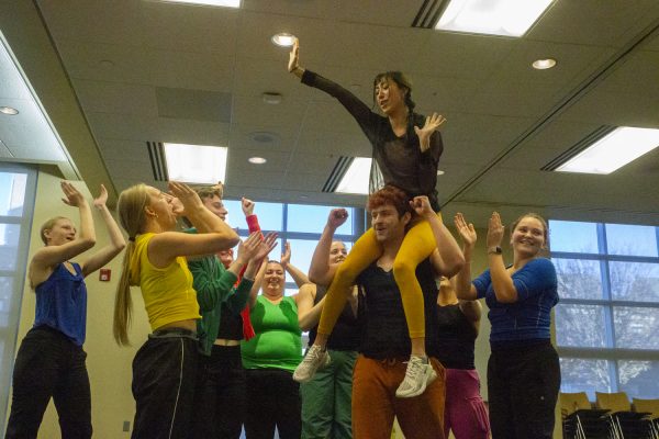 Amelia Fisher is held up by The University of Iowa Dance Company during a performance of “Winning” by Artistic Director Stephanie Miracle, an interactive dance for an audience of children at the Iowa City Public Library on Friday, Nov. 17, 2023.