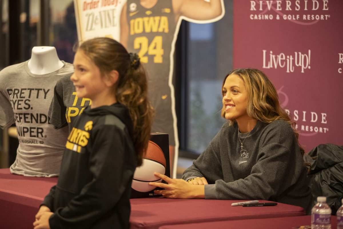 Iowa guard Gabbie Marshall poses for a photo with a fan during a meet and greet with Gabbie Marshall at Riverside Casino and Golf Resort on Friday Nov. 17, 2023. Marshall signed autographs and debuted her new pizza called the “Gabbizza”, the pizza will be served at Riverside’s restaurant, 22 & Vine.